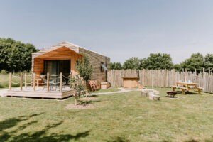 Luxury wooden cabin with decking area, fire pit and hot tub - perfect for a mid-week break