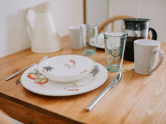 Crockery and cutlery laid on table