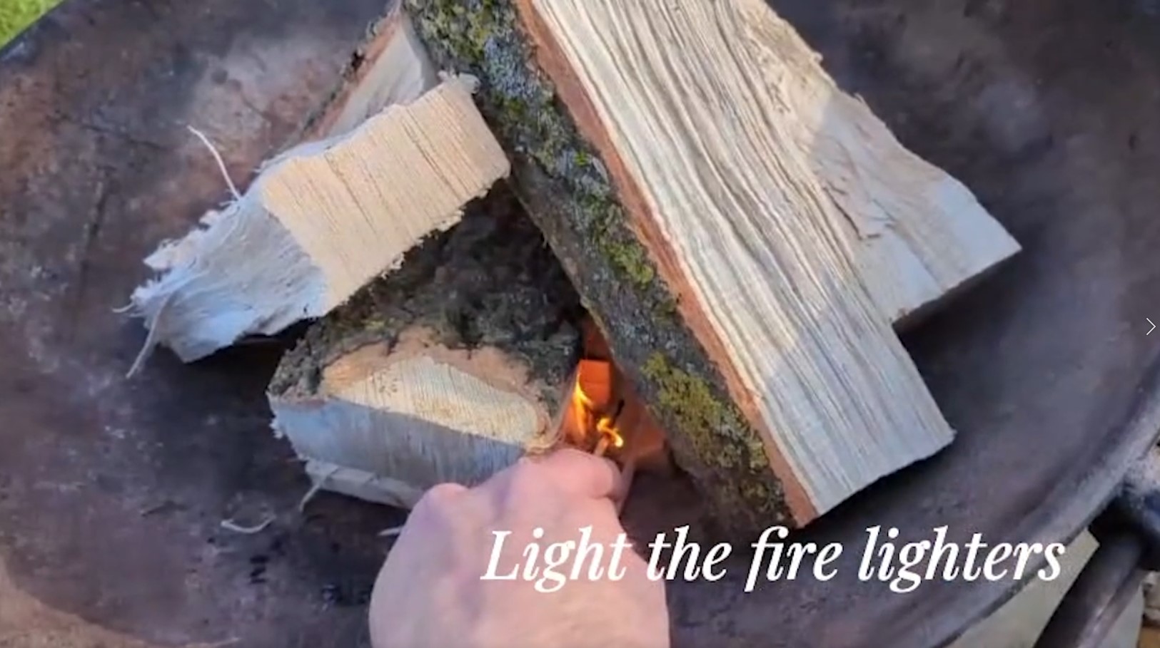 Lighting a fire pit using kindling and firelighters