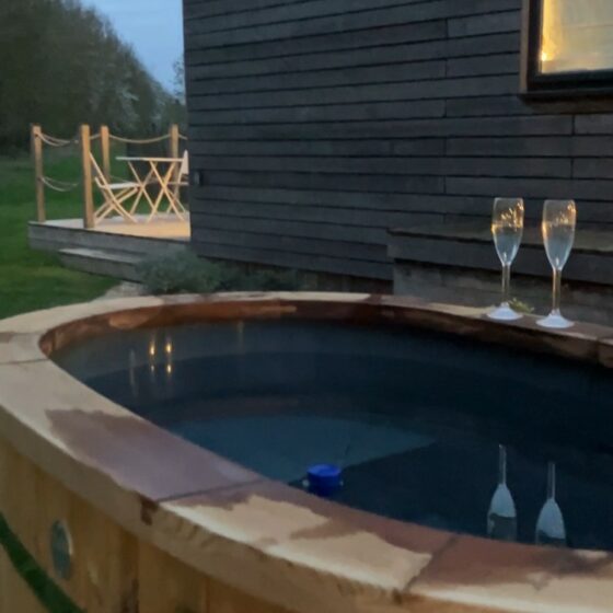 Private wood-fired hot tub at Marigold cabin, The Meadows at Polehanger, perfect for a May spring reset.