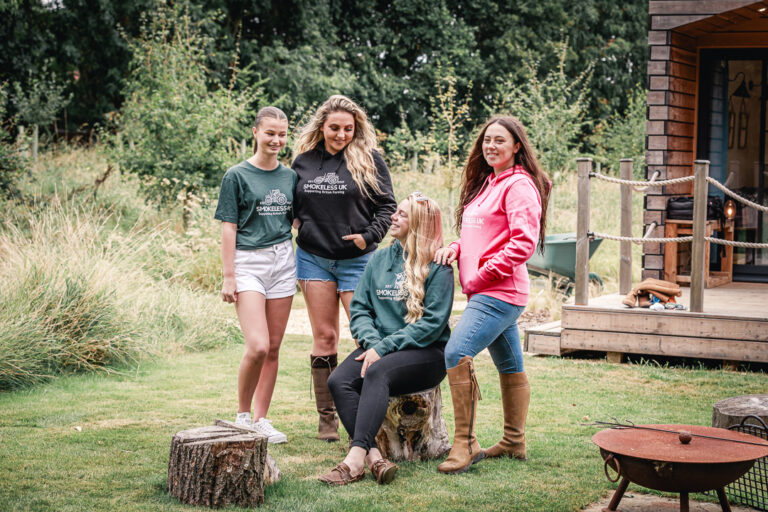A group of guests gathered around a fire pit on their group retreat stay